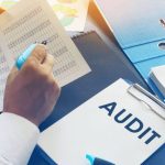 A medical compliance expert discussing QMSR audit questions and documentation with a medical device manufacturer.