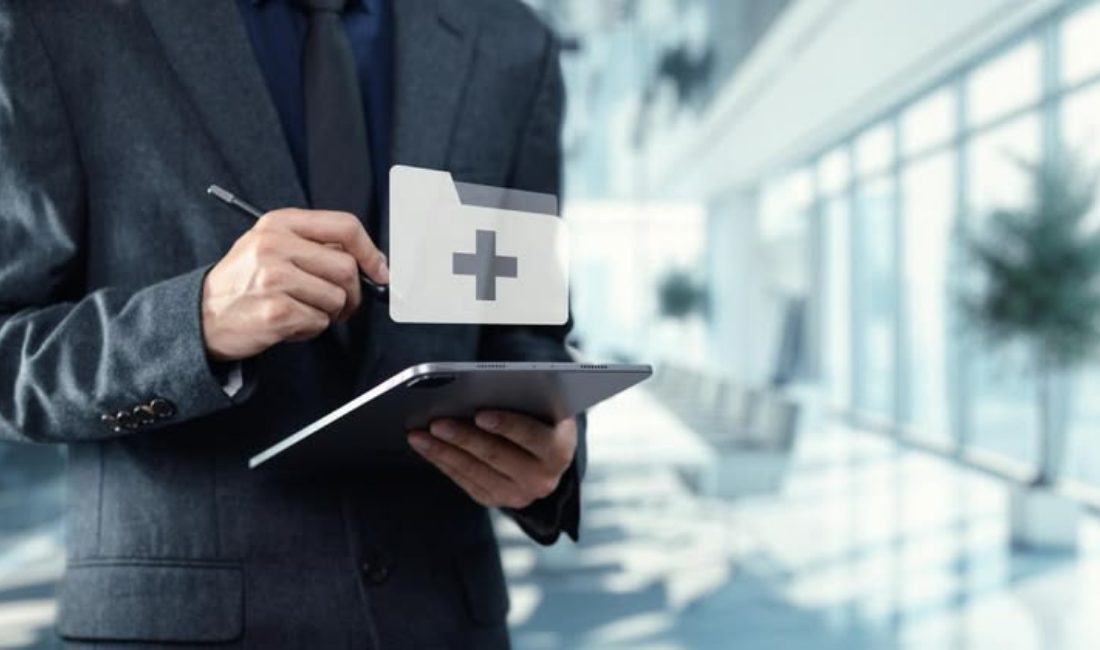 A professional in a suit using a tablet with a digital medical folder icon. This represents a modern FDA inspector or quality manager conducting a digital GMP audit in a clean, corporate facility.